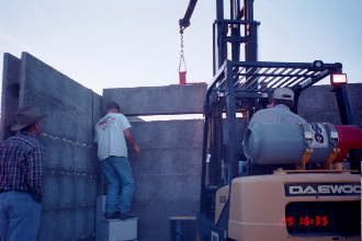 11/29 16:35 Lowering last section of firewall into place.  The use of forklift is a labor-saving convenience.