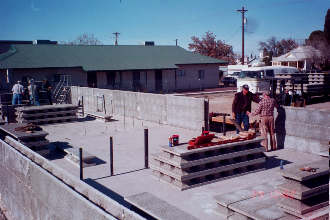 11/29 12:02 Three courses of wall are up.